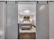 Bedroom with a comfortable bed, neutral color palette, bench, and a view through sliding doors at 579 Brashy St, Woodstock, GA 30188