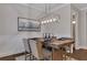 Dining room features a wood table with seating for six and stylish lighting at 579 Brashy St, Woodstock, GA 30188