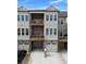 Townhome with two decks and attached garages, showcasing a well-maintained exterior and nice curb appeal at 579 Brashy St, Woodstock, GA 30188