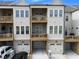Townhome with two decks and attached garages, showcasing a well-maintained exterior and nice curb appeal at 579 Brashy St, Woodstock, GA 30188