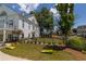 Beautiful community featuring a manicured lawn and charming building exterior with wrought iron fence and outdoor seating at 579 Brashy St, Woodstock, GA 30188