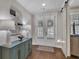Entryway with hardwood floors, attractive console table with decorative lamps, leading to shuttered French doors at 579 Brashy St, Woodstock, GA 30188