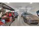 Spacious garage with a golf cart, SUV, and gray Tesla Model Y at 579 Brashy St, Woodstock, GA 30188