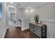 Hallway with hardwood floors, decorative table and access to other rooms at 579 Brashy St, Woodstock, GA 30188