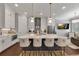 Bright, modern kitchen with an oversized island, stainless steel appliances, and stylish lighting at 579 Brashy St, Woodstock, GA 30188