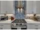 Close-up of a gas range with a stainless steel hood and tile backsplash in a modern kitchen at 579 Brashy St, Woodstock, GA 30188
