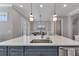 A kitchen island offers a sink and stainless steel dishwasher, while a dining area is visible in the background at 579 Brashy St, Woodstock, GA 30188