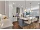Bright kitchen with white cabinets, a gray island, and stainless steel appliances at 579 Brashy St, Woodstock, GA 30188