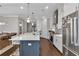 A spacious kitchen has an island with seating, stainless appliances, and hardwood floors at 579 Brashy St, Woodstock, GA 30188