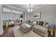 Expansive living room with hardwood floors, a large sectional, and neutral decor at 579 Brashy St, Woodstock, GA 30188