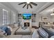 Bright living room with a large sofa, fireplace, and built-in bookshelves at 579 Brashy St, Woodstock, GA 30188