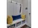 A lovely mudroom features a white bench with storage and colorful pillows at 579 Brashy St, Woodstock, GA 30188