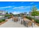 Cozy outdoor seating area with string lights, tables, chairs, and lush landscaping, perfect for socializing at 579 Brashy St, Woodstock, GA 30188