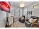 A cozy sitting area features leather recliner chairs, an accent rug, and natural light from shuttered windows at 579 Brashy St, Woodstock, GA 30188