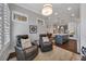 A cozy sitting area is located between a kitchen and dining room with leather recliners and natural light at 579 Brashy St, Woodstock, GA 30188