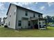 Home back exterior featuring a covered patio with siding and well kept lawn at 7487 Rudder Cir, Fairburn, GA 30213