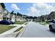 A residential street featuring well-maintained homes and manicured lawns under a blue sky at 7487 Rudder Cir, Fairburn, GA 30213