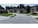 A neighborhood street with well-kept homes, lawns, and parked cars at 7487 Rudder Cir, Fairburn, GA 30213