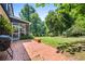 Backyard patio with brick pavers, lush green grass, and views of the home at 285 Jade Cove Dr, Roswell, GA 30075