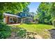 Expansive backyard featuring a lush lawn, screened porch, and brick patio perfect for outdoor entertaining at 285 Jade Cove Dr, Roswell, GA 30075