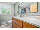 Bathroom with a marble countertop, a wooden vanity, and a large mirror at 285 Jade Cove Dr, Roswell, GA 30075