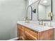 Bathroom with a double vanity, wooden cabinets, and modern fixtures at 285 Jade Cove Dr, Roswell, GA 30075
