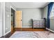 Bright Bedroom features wood floors, a gray changing table, and an open door at 285 Jade Cove Dr, Roswell, GA 30075