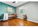 Cozy Bedroom with hardwood floors, a crib, and natural light from the window at 285 Jade Cove Dr, Roswell, GA 30075