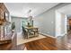 Open dining room with hardwood floors, brick fireplace, table, and an inviting atmosphere at 285 Jade Cove Dr, Roswell, GA 30075