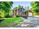Brick home with a well-manicured lawn, attached garage, and a cracked concrete driveway at 285 Jade Cove Dr, Roswell, GA 30075