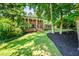 Charming two-story brick home with black mulch, lush green lawn, and shade trees at 285 Jade Cove Dr, Roswell, GA 30075