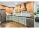 Bright kitchen offering stainless steel appliances, hardwood cabinets, and stone countertops at 285 Jade Cove Dr, Roswell, GA 30075