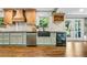 Updated kitchen boasting stainless steel appliances, custom cabinetry, and hardwood floors at 285 Jade Cove Dr, Roswell, GA 30075