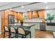 Bright kitchen featuring wood cabinets, stainless steel appliances, sleek countertops, and a kitchen island at 285 Jade Cove Dr, Roswell, GA 30075