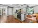 Open kitchen with a center island, an oven, hardwood floors, and seamless transition into the living area at 285 Jade Cove Dr, Roswell, GA 30075