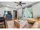 Comfortable living space featuring hardwood floors, a plush sofa, and large windows at 285 Jade Cove Dr, Roswell, GA 30075