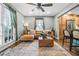 Bright living area featuring hardwood floors, contemporary furnishings, and ample natural light at 285 Jade Cove Dr, Roswell, GA 30075