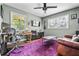 Home office featuring an adjustable desk, a leather couch, and a ceiling fan at 285 Jade Cove Dr, Roswell, GA 30075
