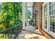 Inviting outdoor porch with rocking chairs, lamps, and brick siding at 285 Jade Cove Dr, Roswell, GA 30075