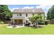 A large backyard includes a patio set, a fire pit, a grill, and mature trees at 4345 Idlewood Dr, Cumming, GA 30040