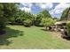 Expansive backyard with lush green lawn and mature trees providing privacy at 4345 Idlewood Dr, Cumming, GA 30040