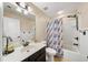 Bright bathroom features a single sink vanity, a tub and shower combination, and blue accents at 4345 Idlewood Dr, Cumming, GA 30040