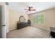 Bedroom with a large window, a dark dresser with mirror, a ceiling fan and an office chair at 4345 Idlewood Dr, Cumming, GA 30040
