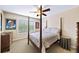 This bedroom features a four-poster bed, neutral walls, a ceiling fan, and two colorful framed art pieces at 4345 Idlewood Dr, Cumming, GA 30040