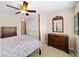Bedroom with a four-poster bed, dark wooden dresser, neutral walls, and a ceiling fan at 4345 Idlewood Dr, Cumming, GA 30040