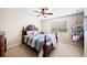 Cozy bedroom with decorative hanging chair, a ceiling fan, and a bed with a striped comforter at 4345 Idlewood Dr, Cumming, GA 30040