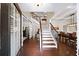 Grand foyer showcasing hardwood floors, a staircase with decorative railings, and an open layout leading to the dining area at 4345 Idlewood Dr, Cumming, GA 30040