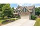 Beautiful two-story home featuring a brick facade, well-kept lawn, and attached two-car garage in a lovely suburban setting at 4345 Idlewood Dr, Cumming, GA 30040
