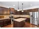 Stylish kitchen showcasing stainless steel appliances, dark wood cabinets, and granite countertops at 4345 Idlewood Dr, Cumming, GA 30040