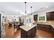 Open kitchen with stainless steel appliances, granite countertops, and seamless flow to living spaces at 4345 Idlewood Dr, Cumming, GA 30040